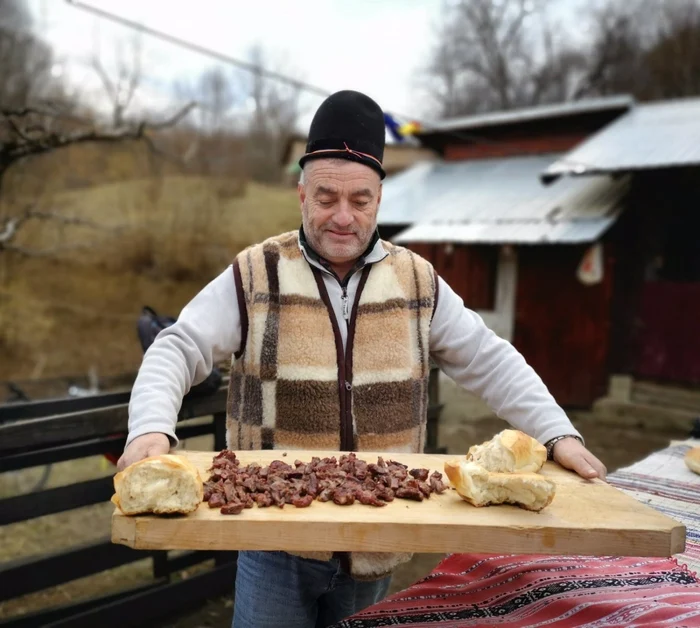 Shepherd carrying a wooden countertop with flesh and bread goodies