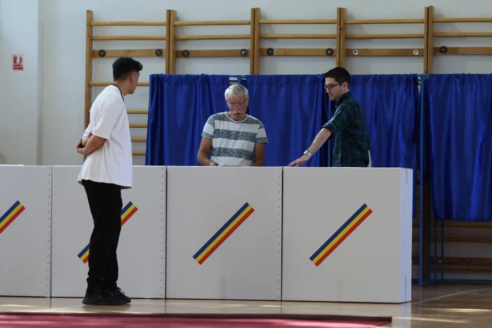 Young people next to the ballot boxes in a polling station