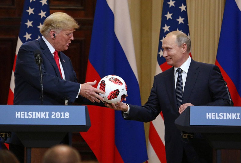 Donald Trump receives football from Vladimir Putin during a joint press conference. Helsinki, 16 July 2018
