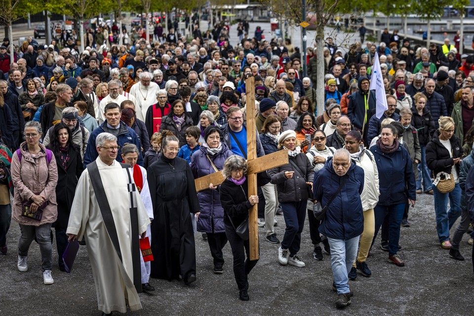 The faithful pass through the streets of Zurich during the procession of the Way of the Cross on Good Friday