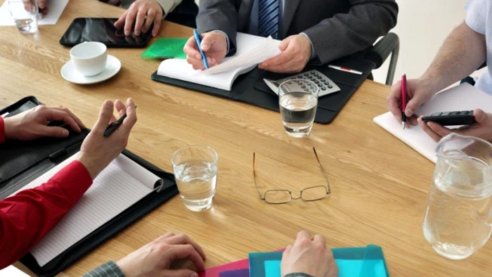 More people negotiate a mortgage loan, sitting at a meal