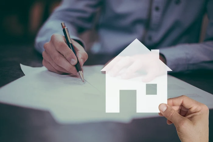 Someone signs the contract for the purchase of a house at the notary