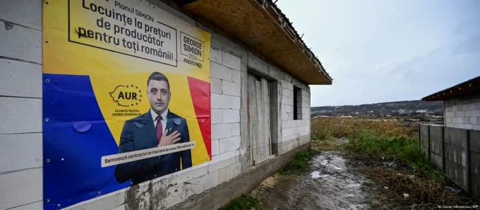 An electoral poster with George Simion in a flood-affected village (November 2024 image)