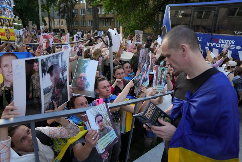 Relatives and friends of Ukrainian prisoners of war welcome their loved ones after replacing prisoners in an undisclosed place in Ukraine, on May 23, 2025.