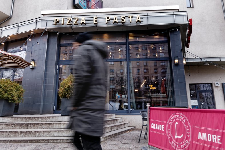 Passerby. Restaurant at Alexanderplatz in Berlin. Germany. 2023
