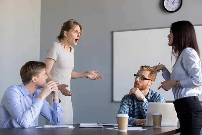 Two men look at how two service colleagues quarrel
