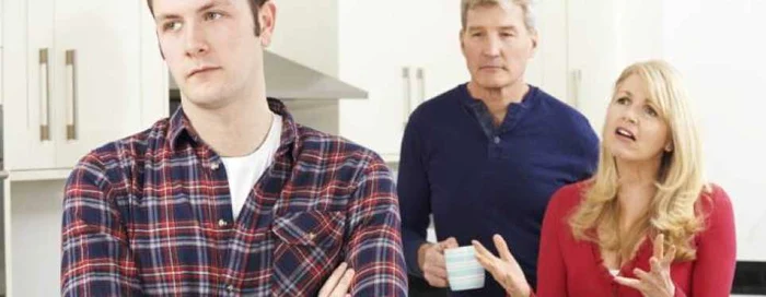 A young man looked to one side, inattentive when he is quarreling with his parents