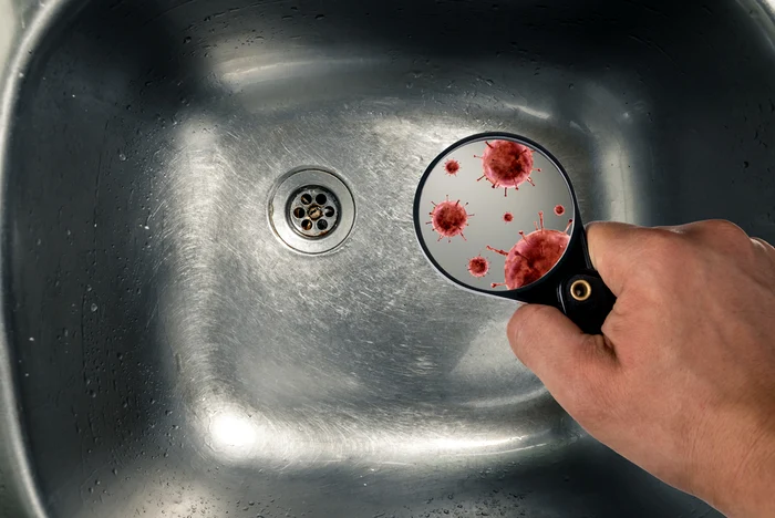 A magnifying glass looking for bacteria in a sink photo archive Adevăr