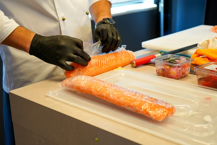 Someone prepares sushi