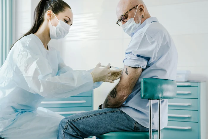 An assistant who vaccinates a PEXELS photo man