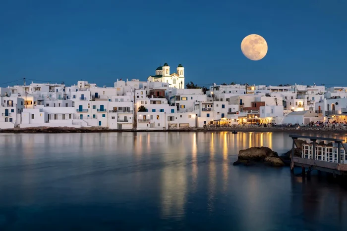 The island of Paros from Greece seen at night from the sea photo eskapas