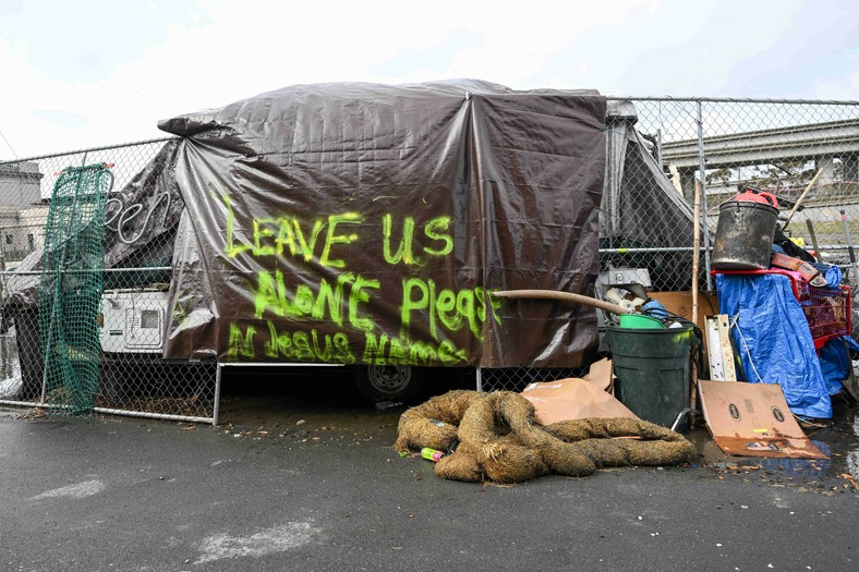 The homeless camp on the street in West Oakland, California, the inscription says: "Leave us alone"