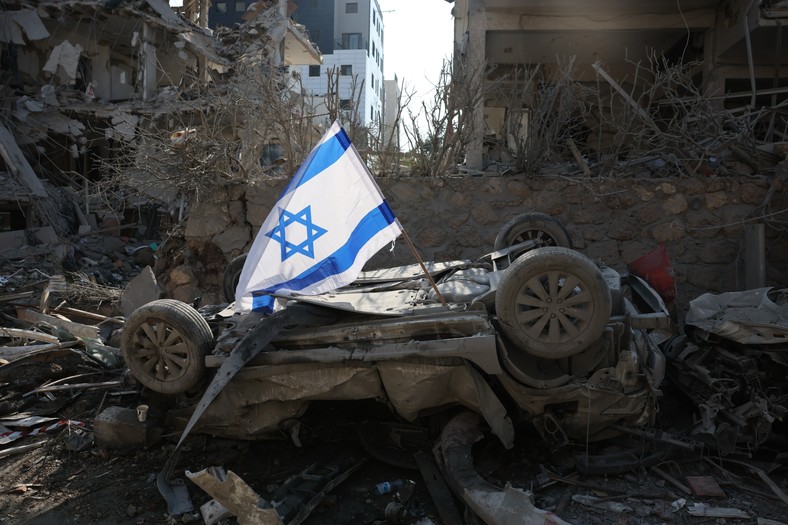 Israeli flag on a damaged car after hitting a ballistic missile in a residential district in Ramat Gan, near Tel Aviv, Israel, June 14, 2025.