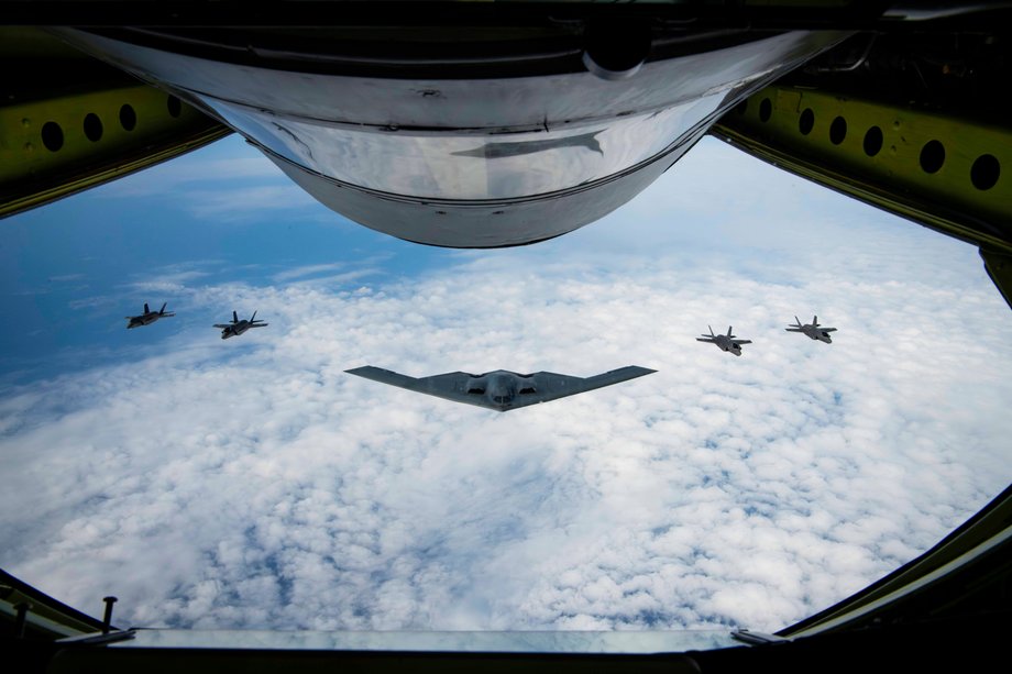 Stealth B-2 bomber SPIRIT USA Air Force flying with f-35 lightning ii joint strike fighters fighters.