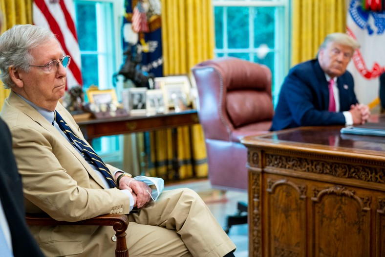 Mitch McConnell listens to Donald Trump's speech to journalists during a meeting with the Republican leaders of the Congress and members of the Trump's office in the oval office in the White House, July 20, 2020.