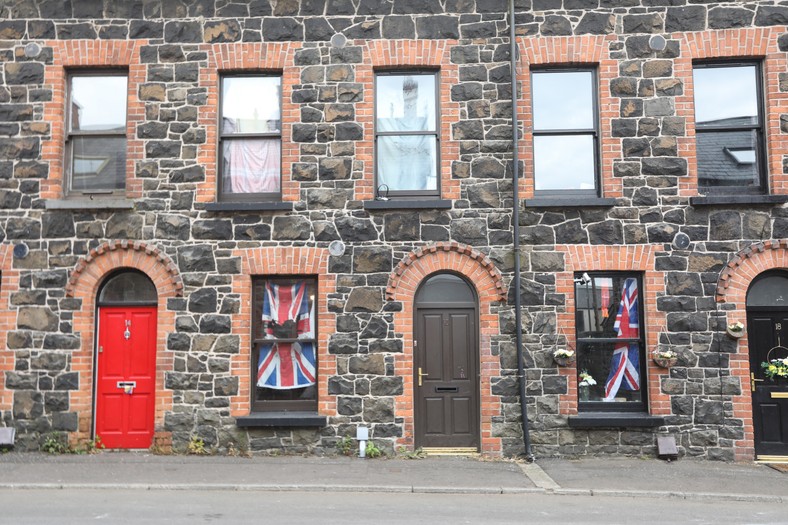 A building with posted flags of Great Britain in Ballymena, Northern Ireland, June 12, 2025.