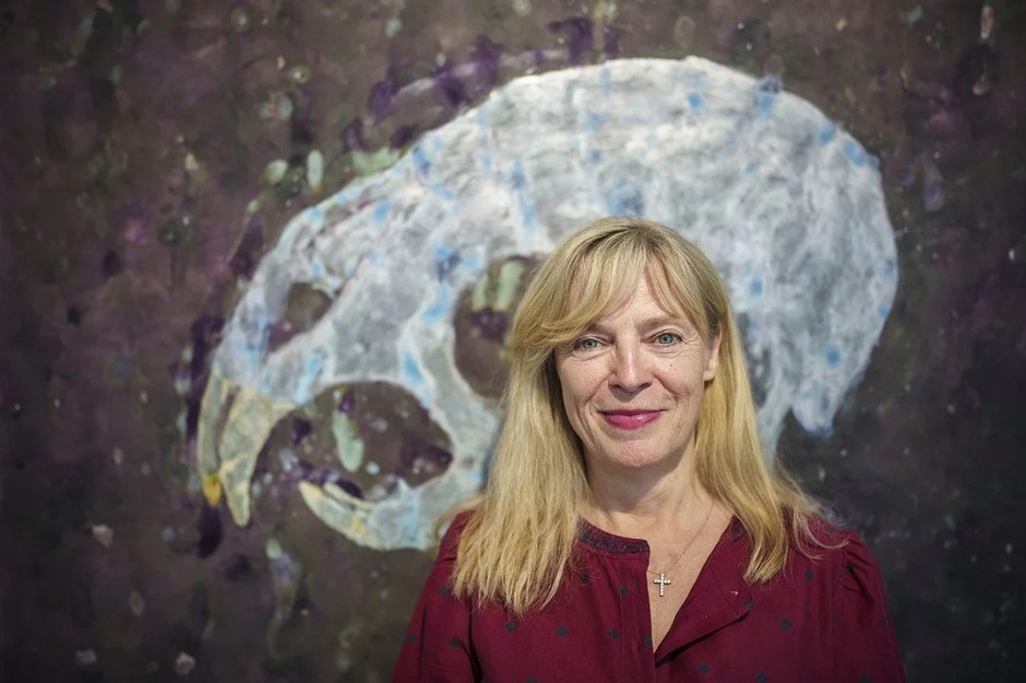Erika Bornov against the background of her work