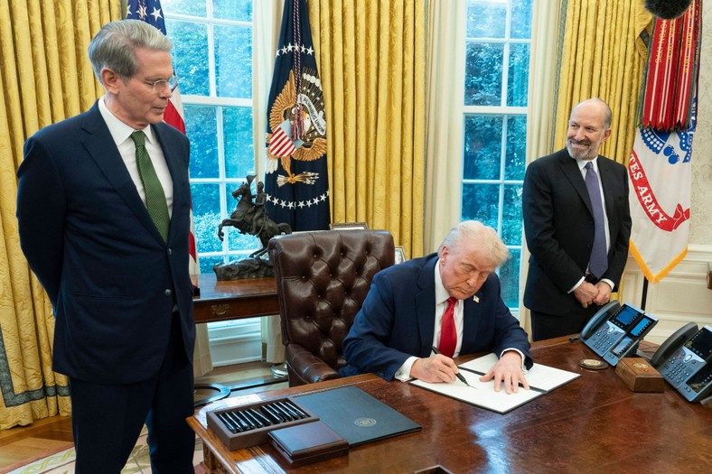 US President Donald J. Trump while signing decrees in the Oval Office of the White House in the presence of the Secretary of Treasury Scott Bessenta (L) and Secretary of Trade Howard Lutnicka (P), Washington, USA, February 3, 2025.