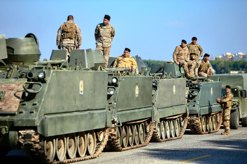 Soldiers of the Lebanese army on board armored military vehicles secure the area after the withdrawal of Israeli army from the seaside city of An-Nakura near the border with Israel, Lebanon, January 7, 2025.