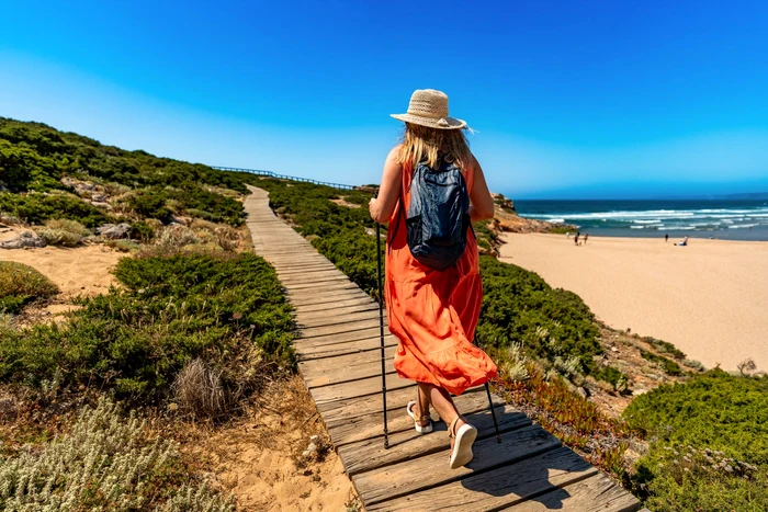 A woman walking on an alley arranged on the shore of the shutterstock photo