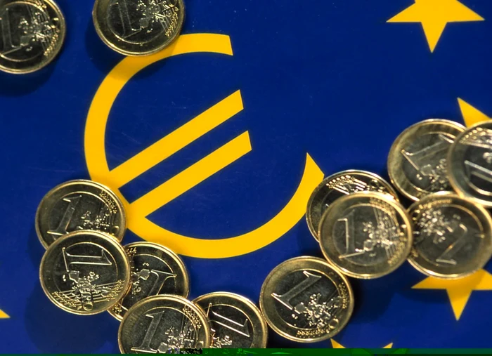 Euro coins over the flag of the European Union