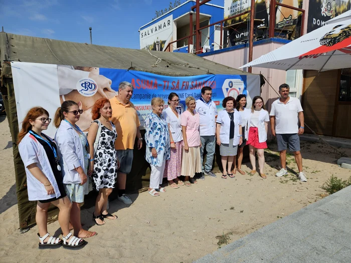 Doctors on the coast with the campaign banner behind them