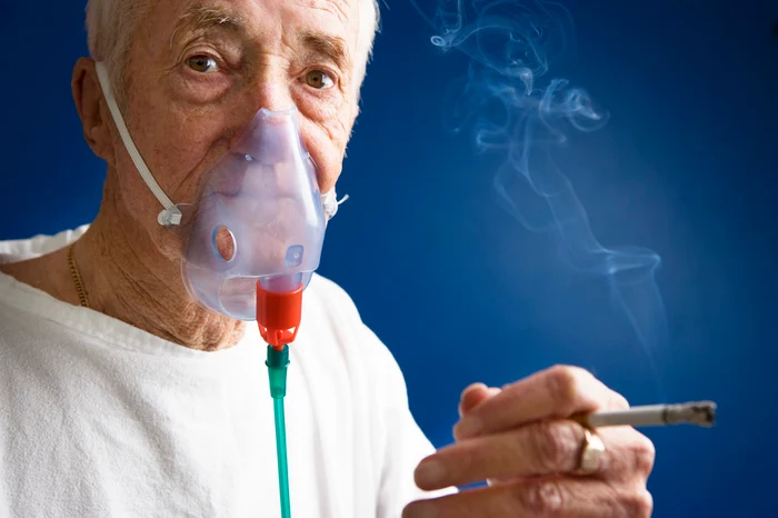 Man with face mask and cigarette in hand symbolizing the risk for diabetes photocarcareeverywhere