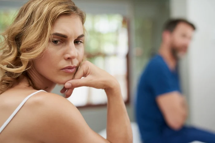 couple, blonde woman, white strap, man in blue in the area