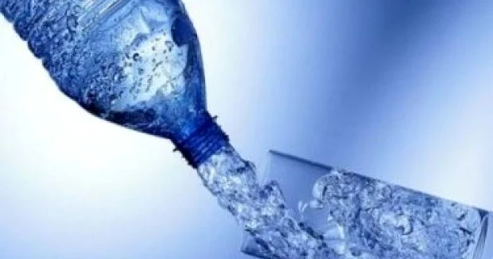 Mineral water poured from glass into a glass