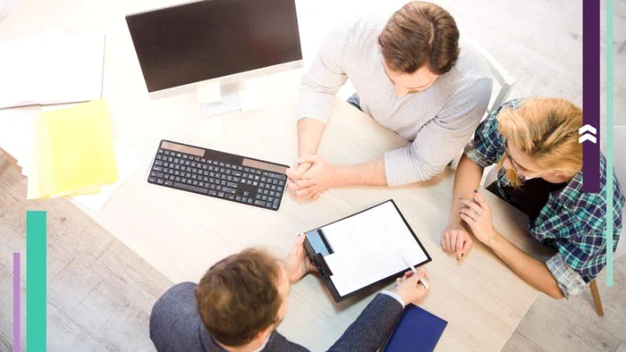 Two young people are advised by a bank employee for a mortgage loan