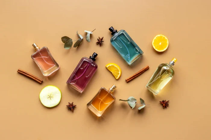Perfumes beside slices of lemon and cinnamon