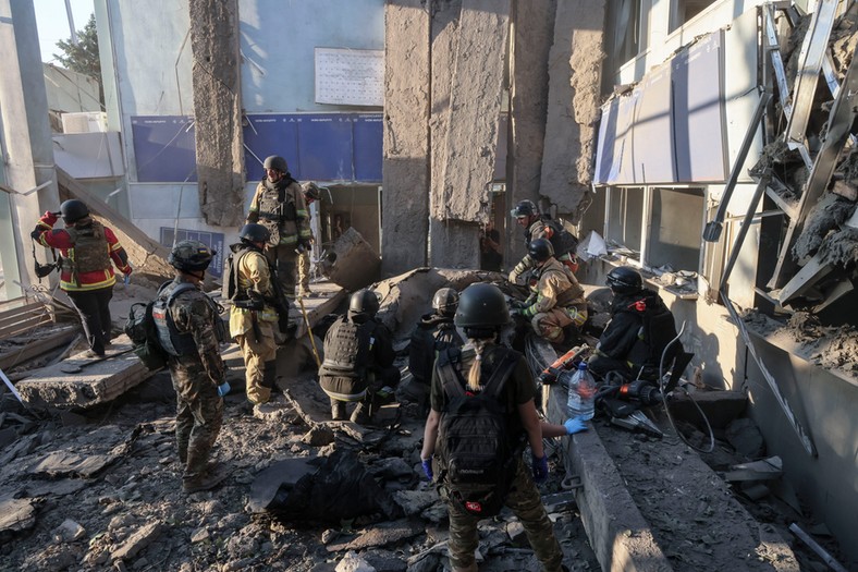 Rescuers and policemen on the site of a Russian attack on the bus station in Zaporozhye, August 10, 2025.
