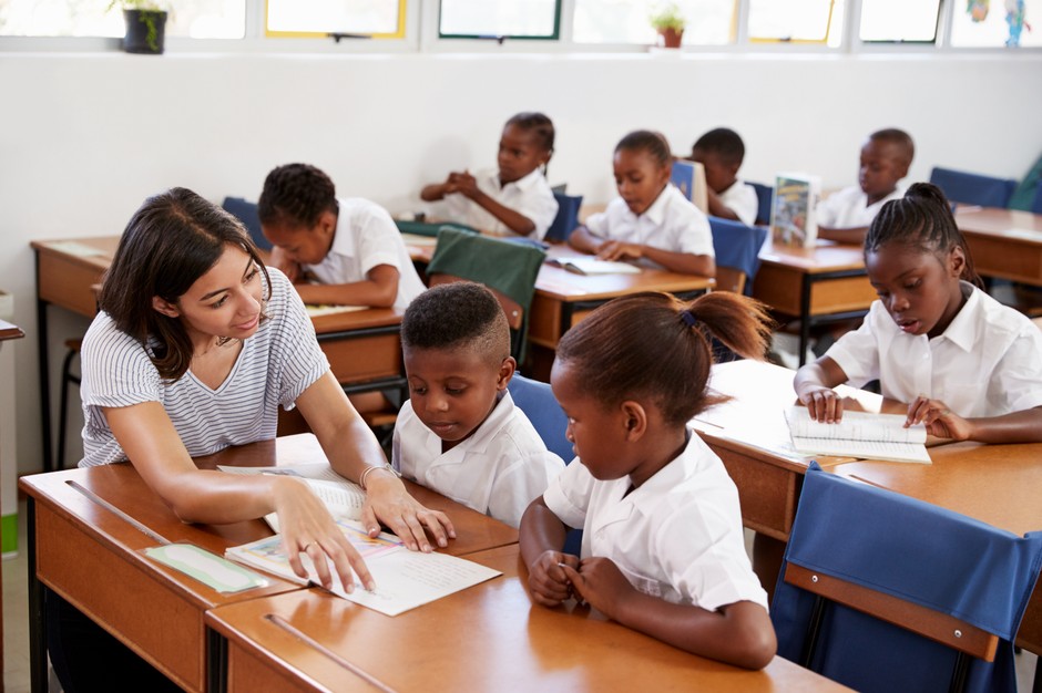 Teacher with children at school. Illustrative photo