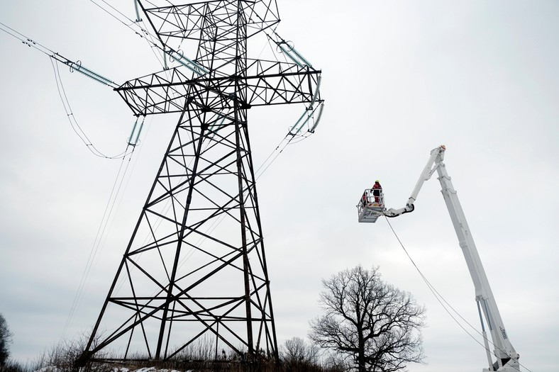 Specialists crossing the power line at the border of Russia and Latvia, February 8, 2025. Baltic states disconnected from the Russian energy network to join the EU and ensure energy security