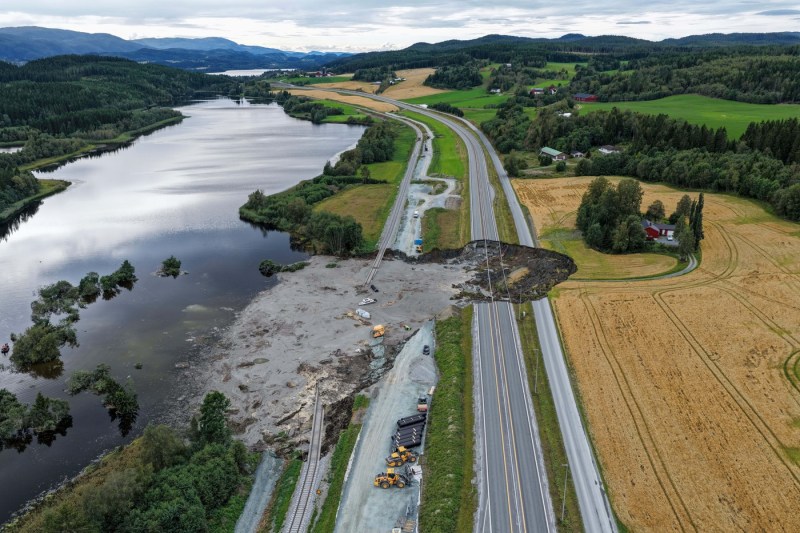 A highway and railway, severely affected by a landslide in Norway. The possible cause of the incident