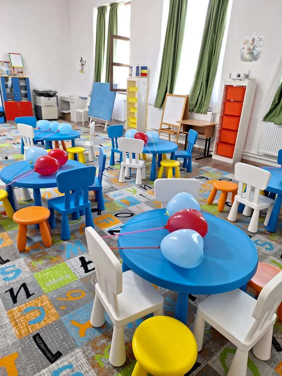 The interior of a private kindergarten with colorful chairs and tables