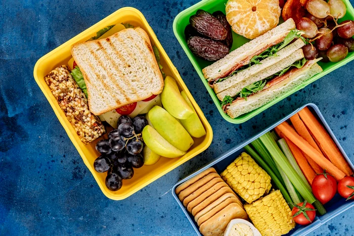 School packs with fruit, vegetables, biscuits