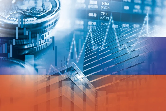 Photo collage with rubles and stock charts over Russian flag