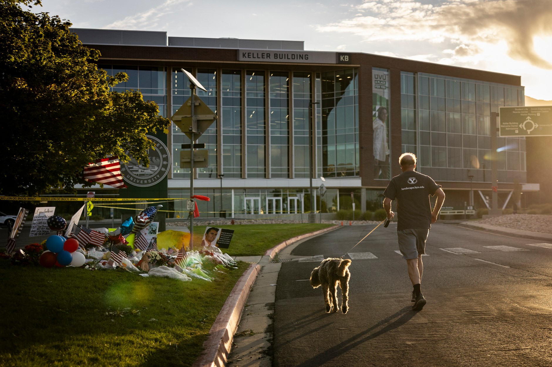 The runner passes the memorial place dedicated to Charlie Kirk at the Utah Valley University in Orem, September 13, 2025.