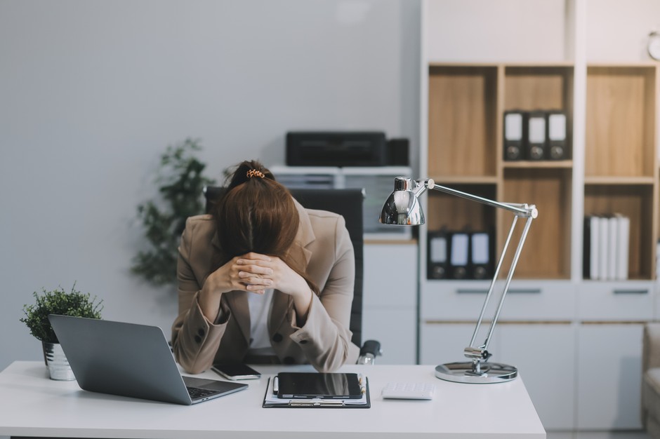 A tired woman at work. Illustrative photo