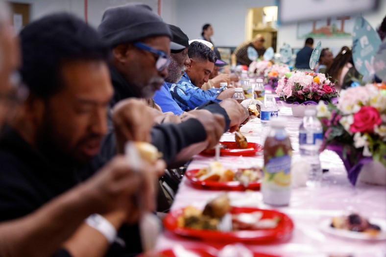 People in the crisis of homelessness eating free meals served by Los Angeles Mission in Los Angeles, USA, March 29, 2024.