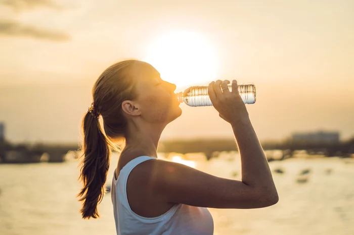 woman who drinks white -dressed water