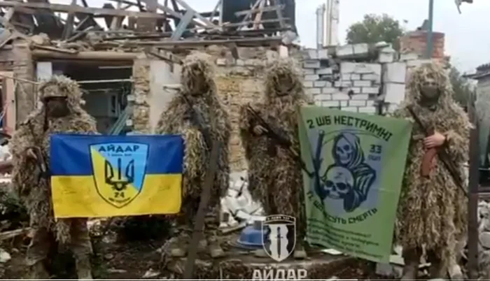 Ukrainian forces flown the flag of Ukraine in the locality photo capture