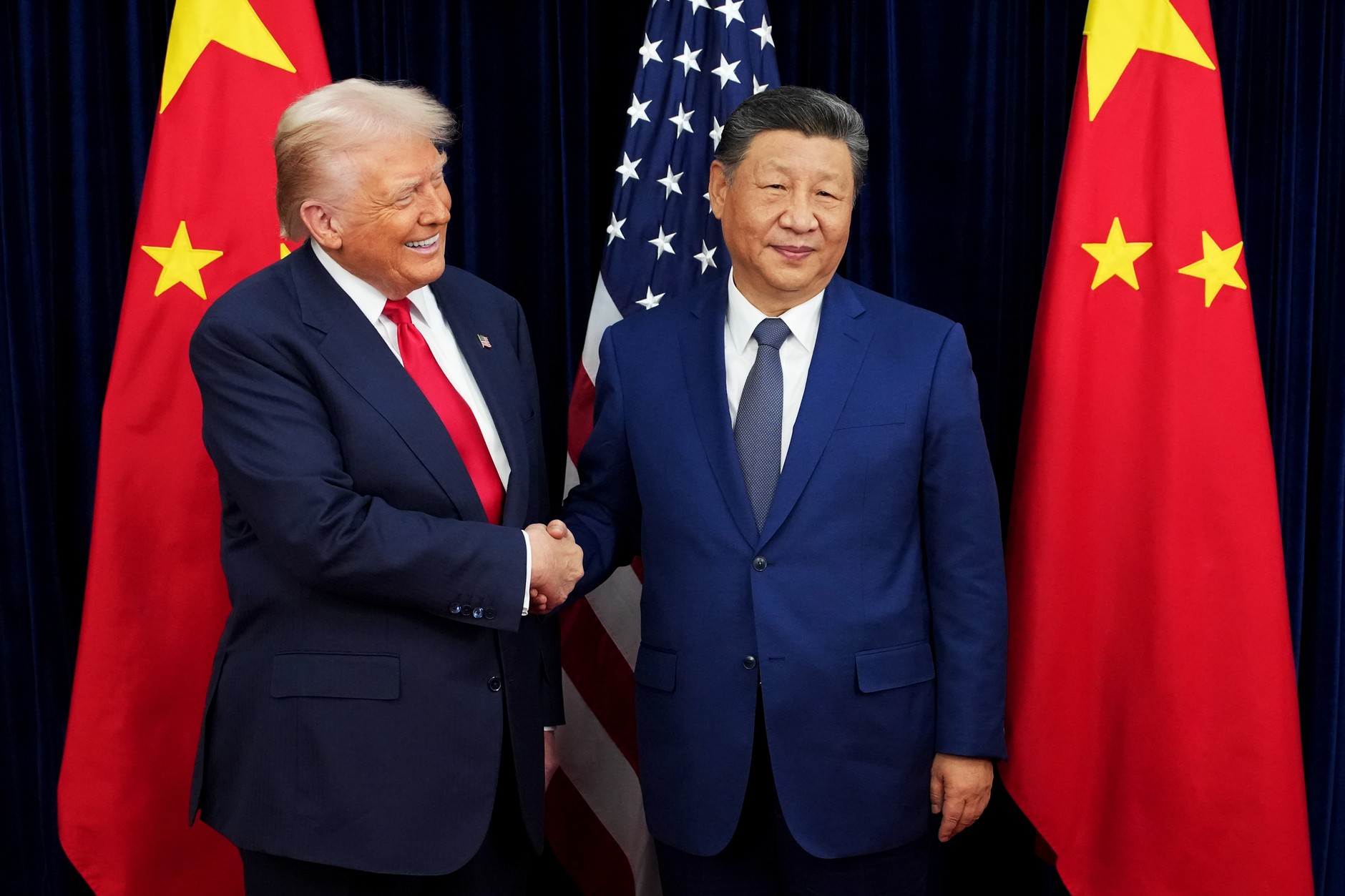 U.S. President Donald Trump greets Chinese leader Xi Jinping ahead of a bilateral meeting in Busan, South Korea, October 30, 2025.