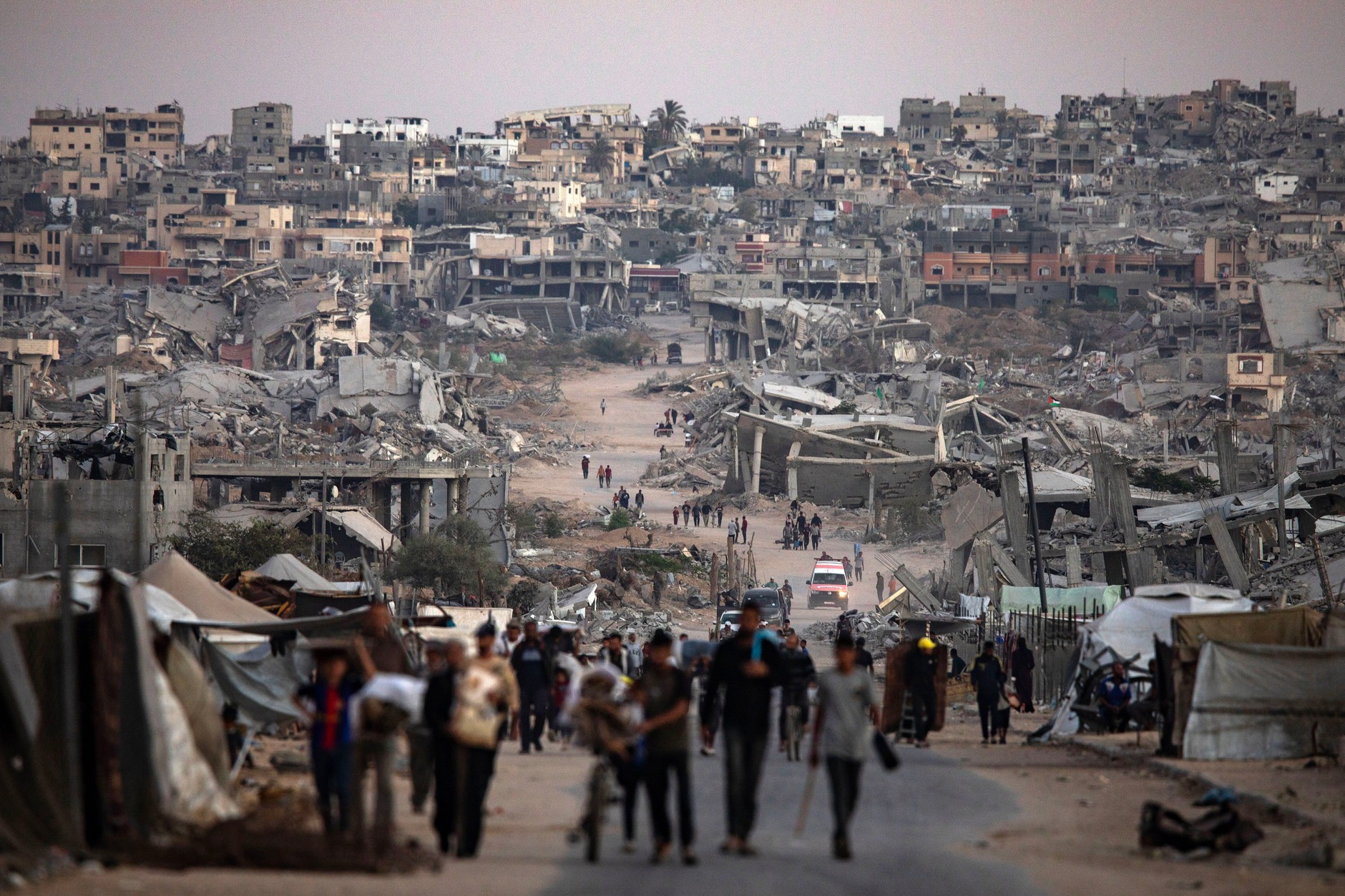 Palestinians among the ruins of houses in Khan Yunus, October 25, 2025.