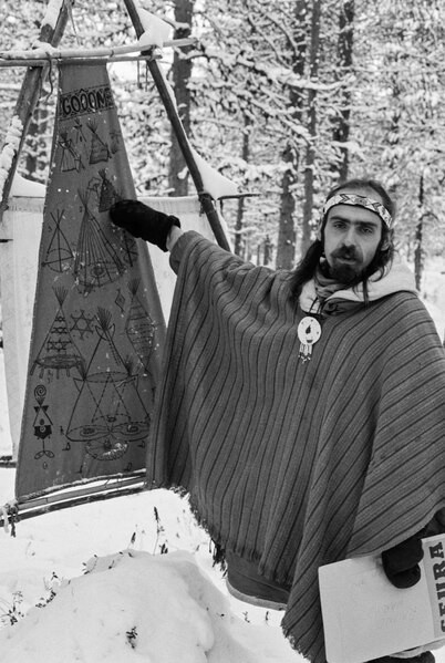 A member of the Iriadamant group presenting construction drawings of their tents