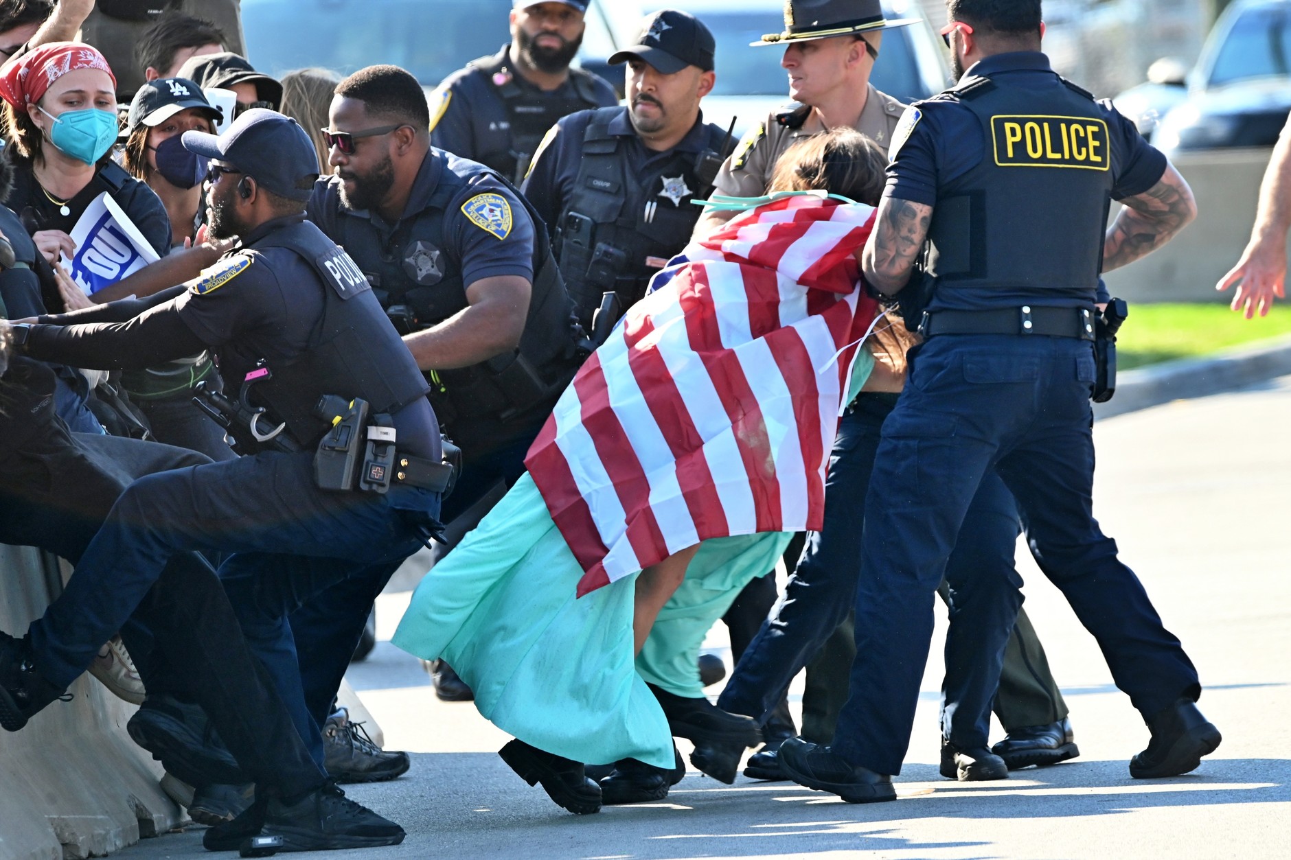 Police detain a protester during a rally outside an ICE building after recently dismantling the facility's security fence in Broadview, Illinois, Chicago, October 17, 2025.