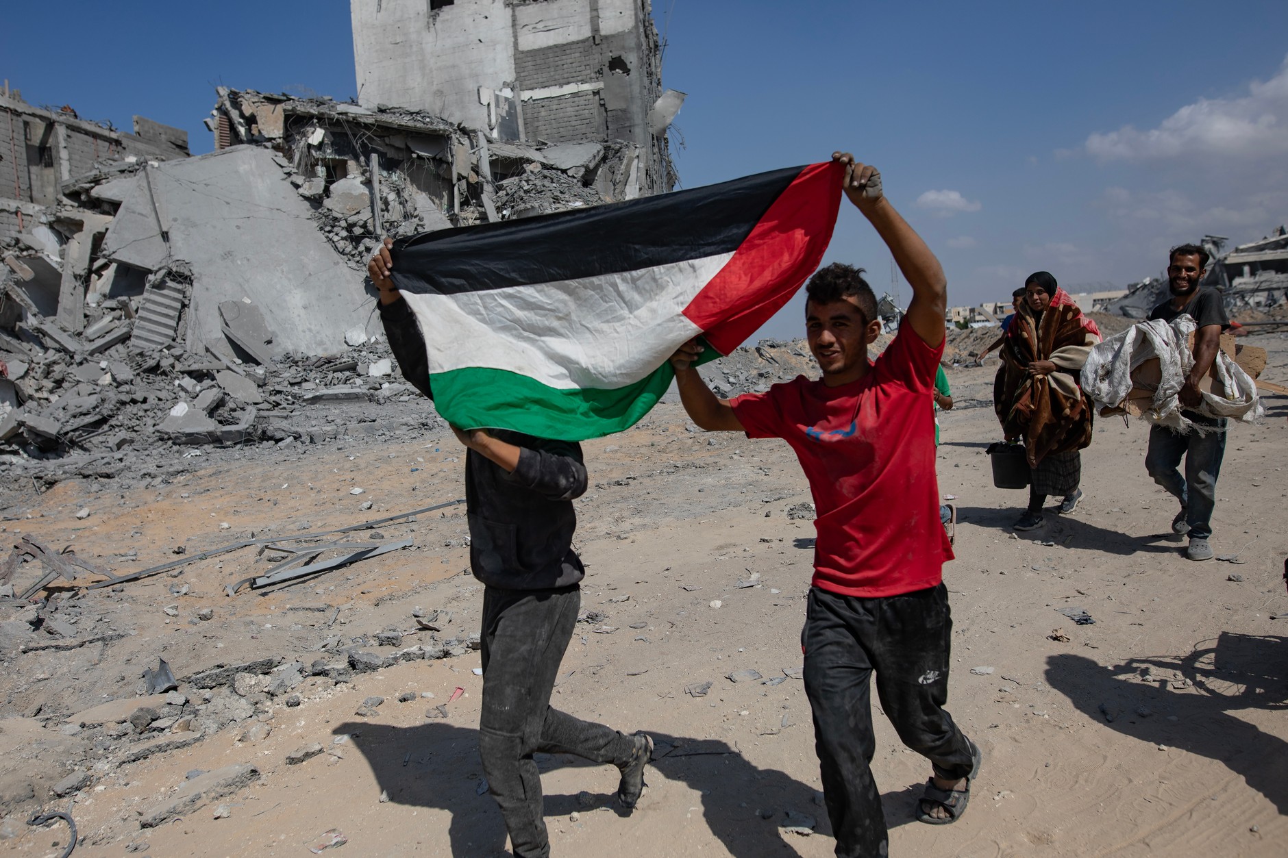 Palestinians in the destroyed Khan Yunus