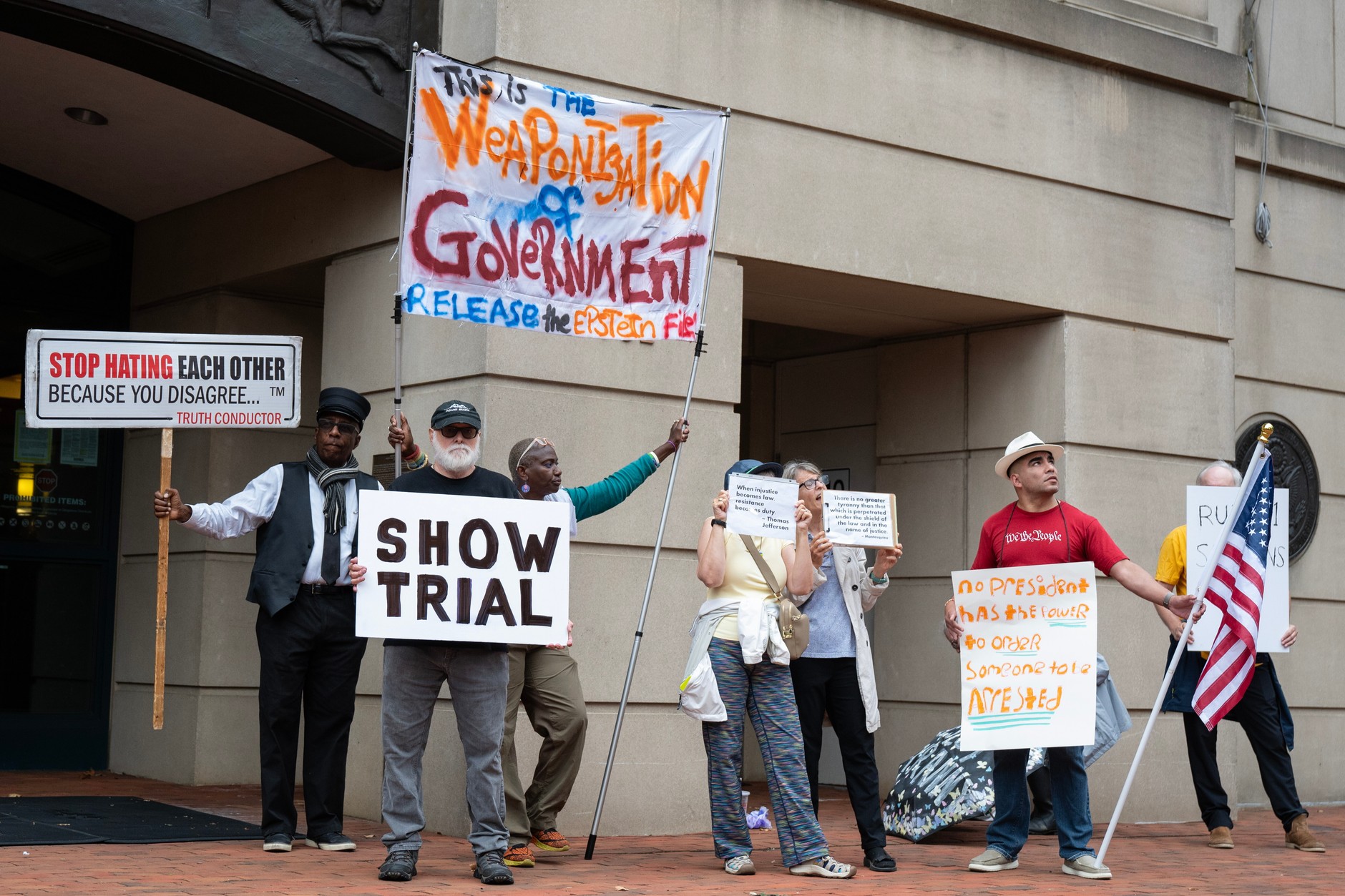 Protesters outside a federal courthouse in Alexandria, Virginia, during the hearing of FBI Director James Comey, U.S., October 8, 2025.