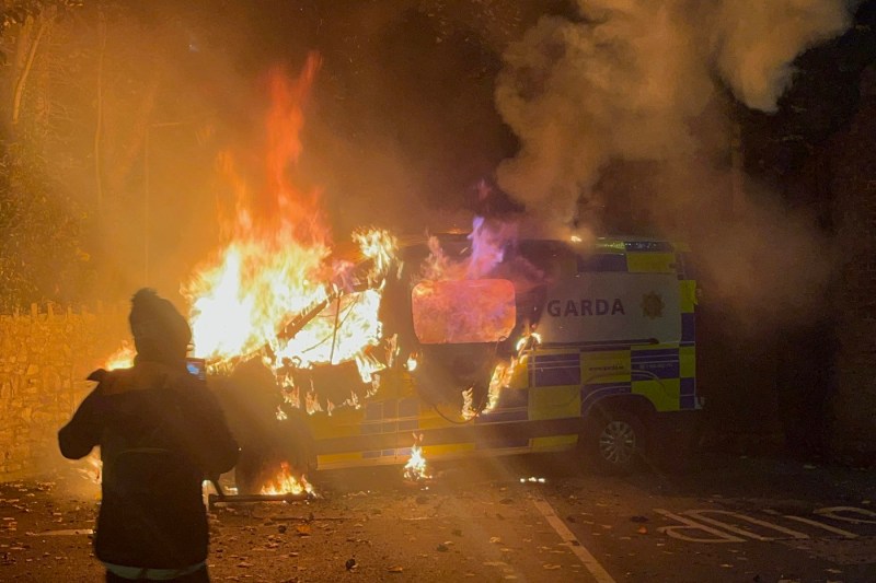Violent protests at a migrant hotel in Dublin. Police car set on fire by angry mob over alleged rape